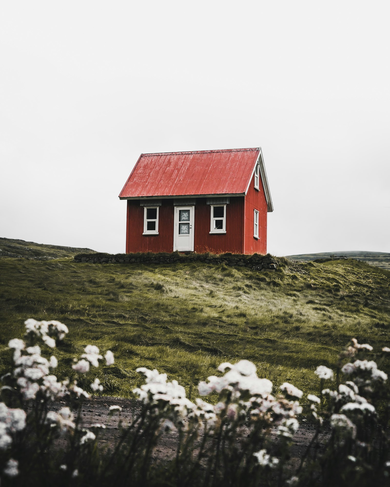 A small standalone heritage cottage with white-trimmed windows (placeholder photo)