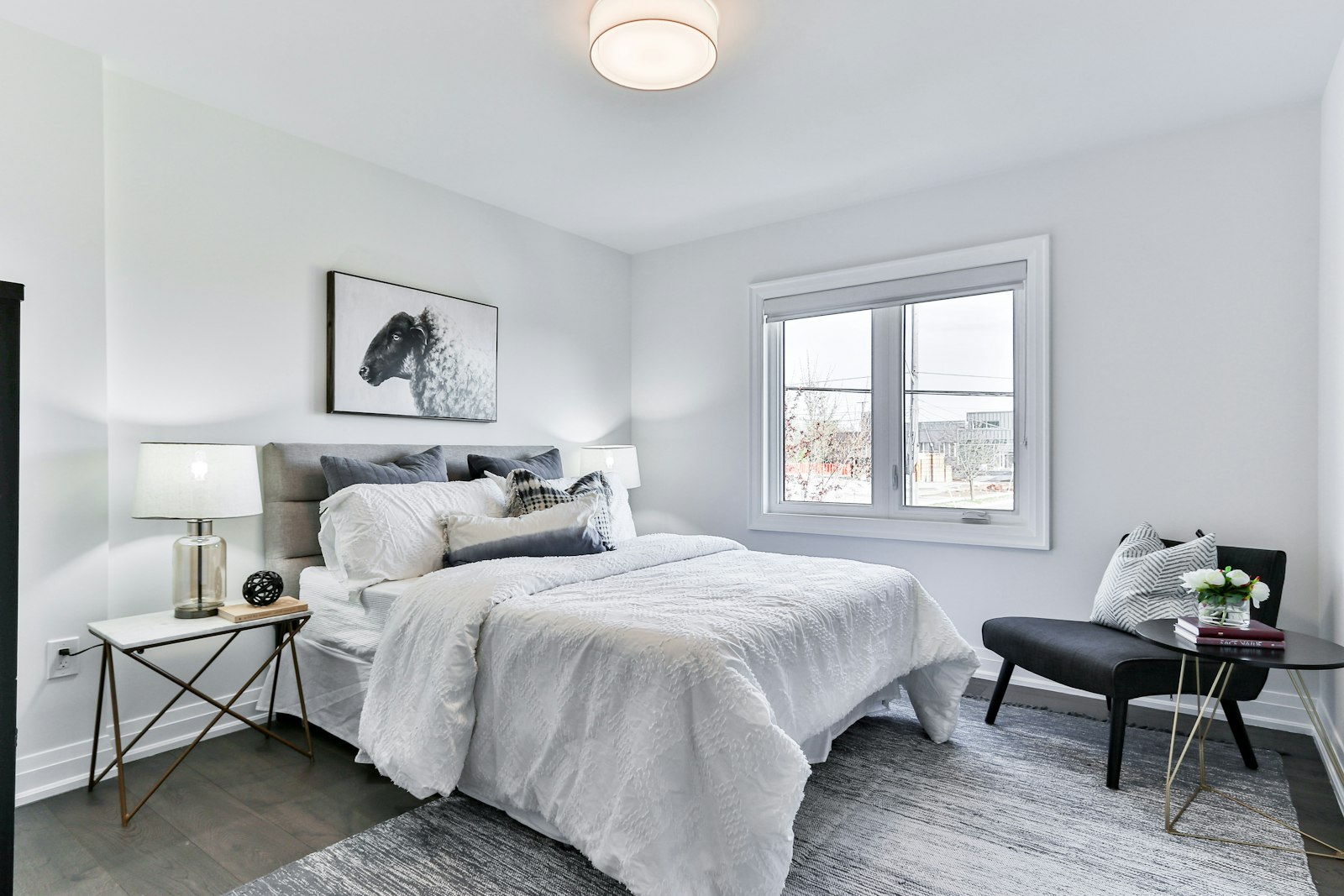 A bright, tidy bedroom with pale walls and soft daylight (placeholder photo)